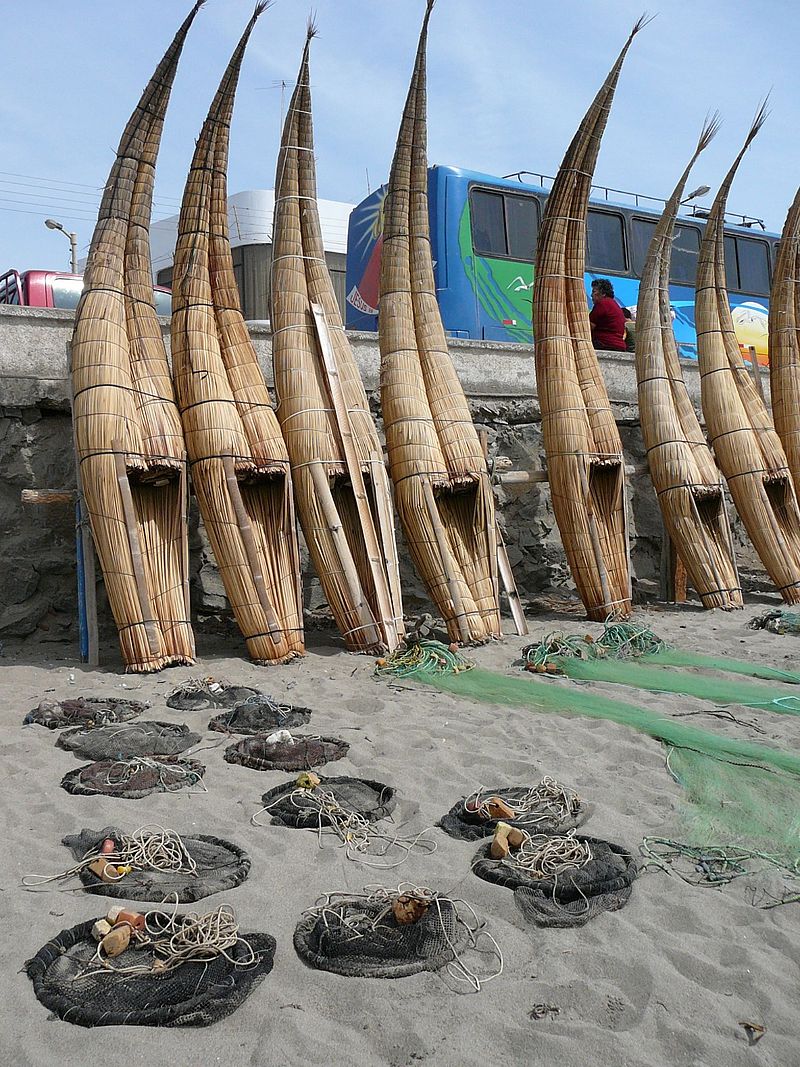 standing Peruvian fishing boats, caballitos de totora, fishing nets