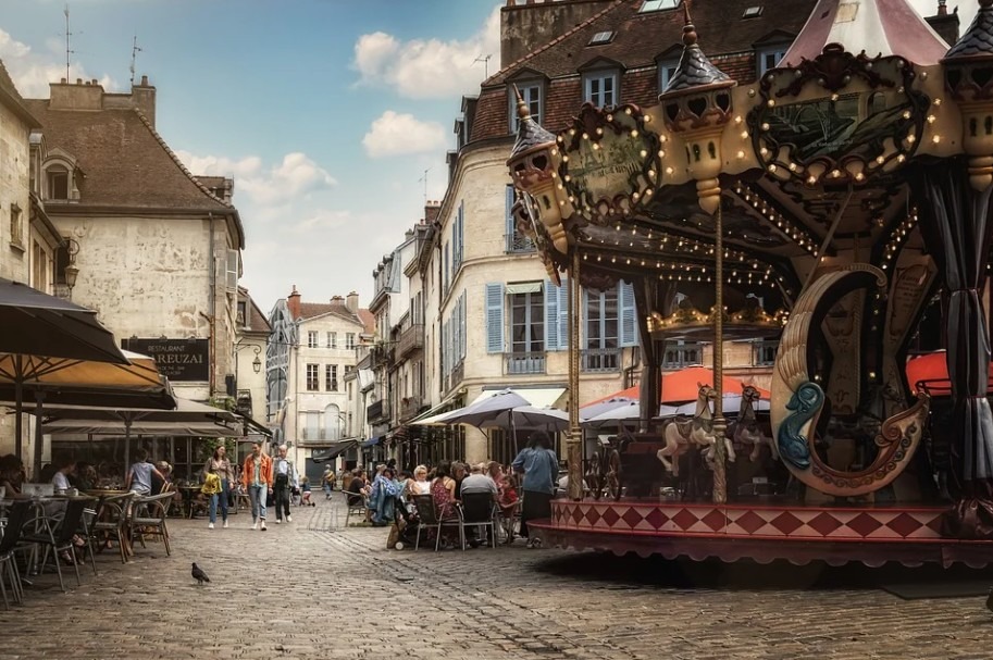 an old street in France, people talking, carousel, old houses, old street photography