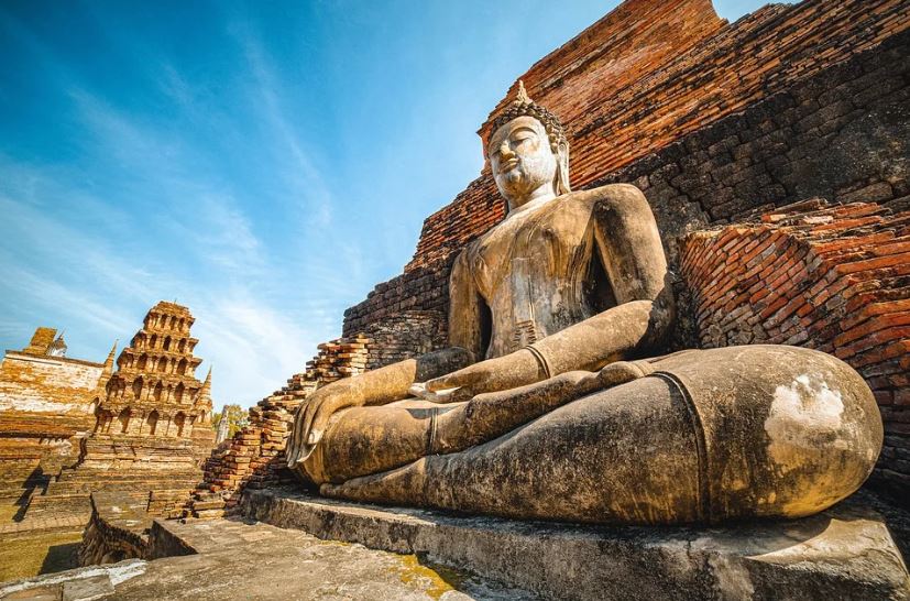 Buddha statue, brick walls, blue sky
