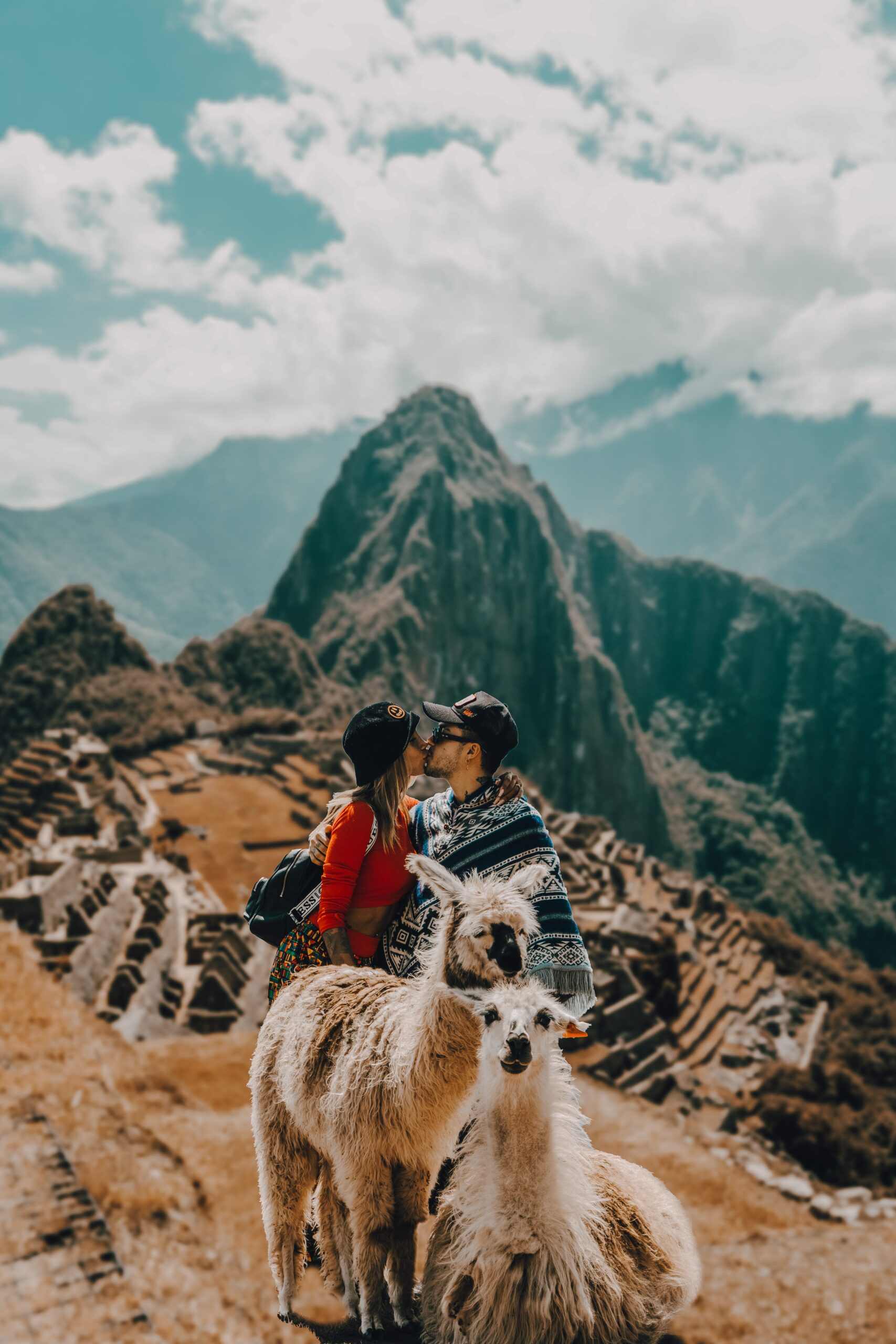 A couple standing on a mountain on the background of Machu