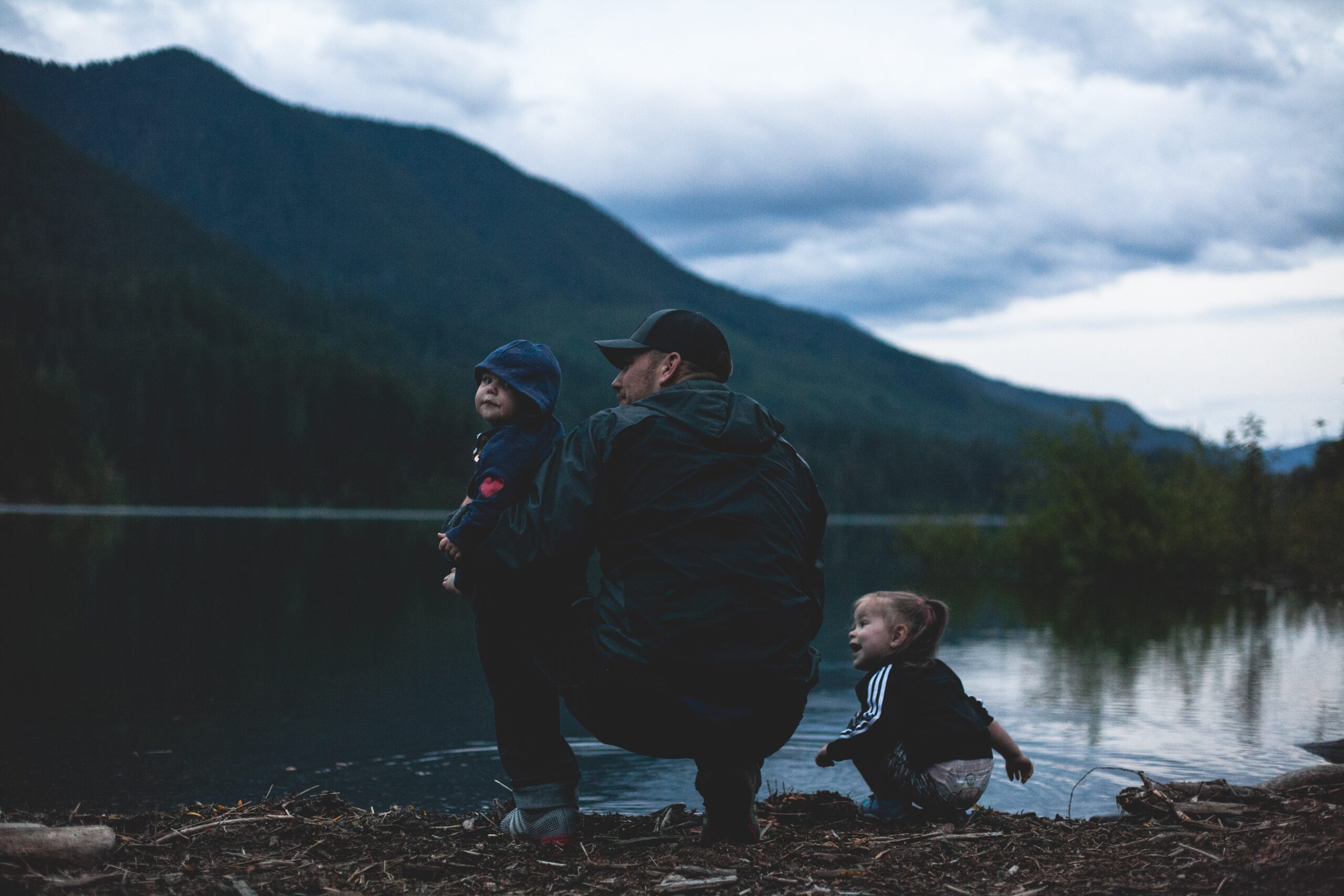 A father and his kids near a body of water